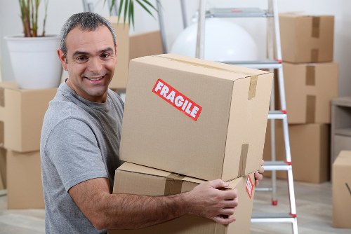 Moving team loading household items safely into a van