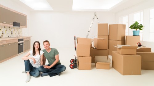 Boxes and furniture arranged in a new Eastcote home after moving