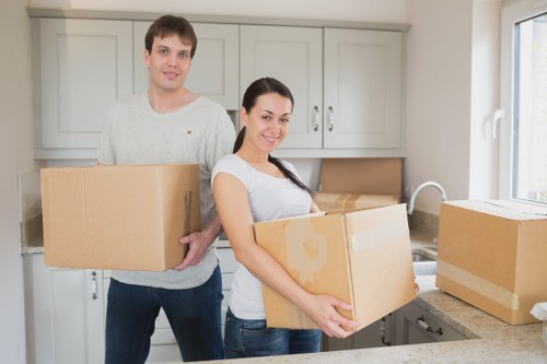 Removal team carrying boxes from a property in Eastcote